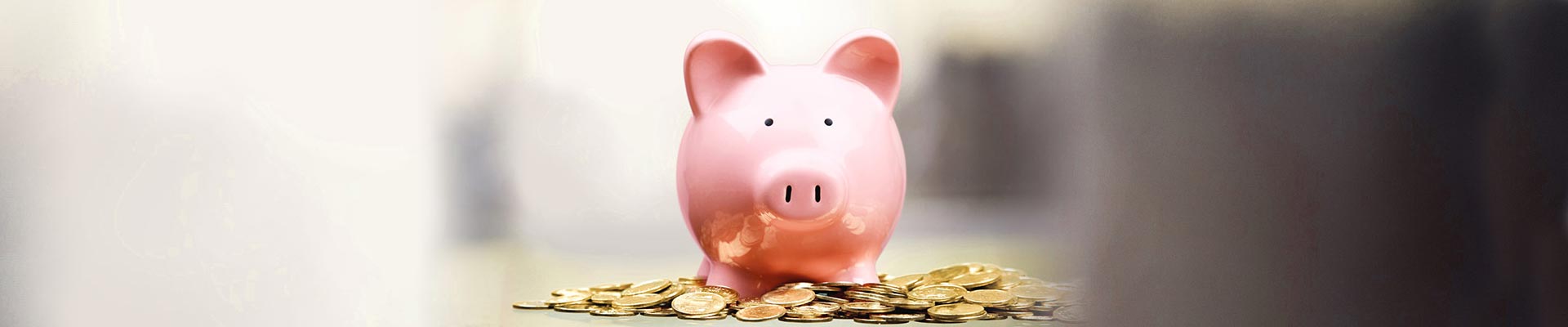 pink piggy bank with coins